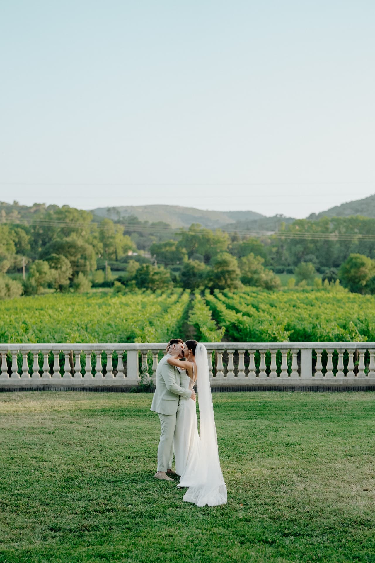 Couple kissing before the vineyard