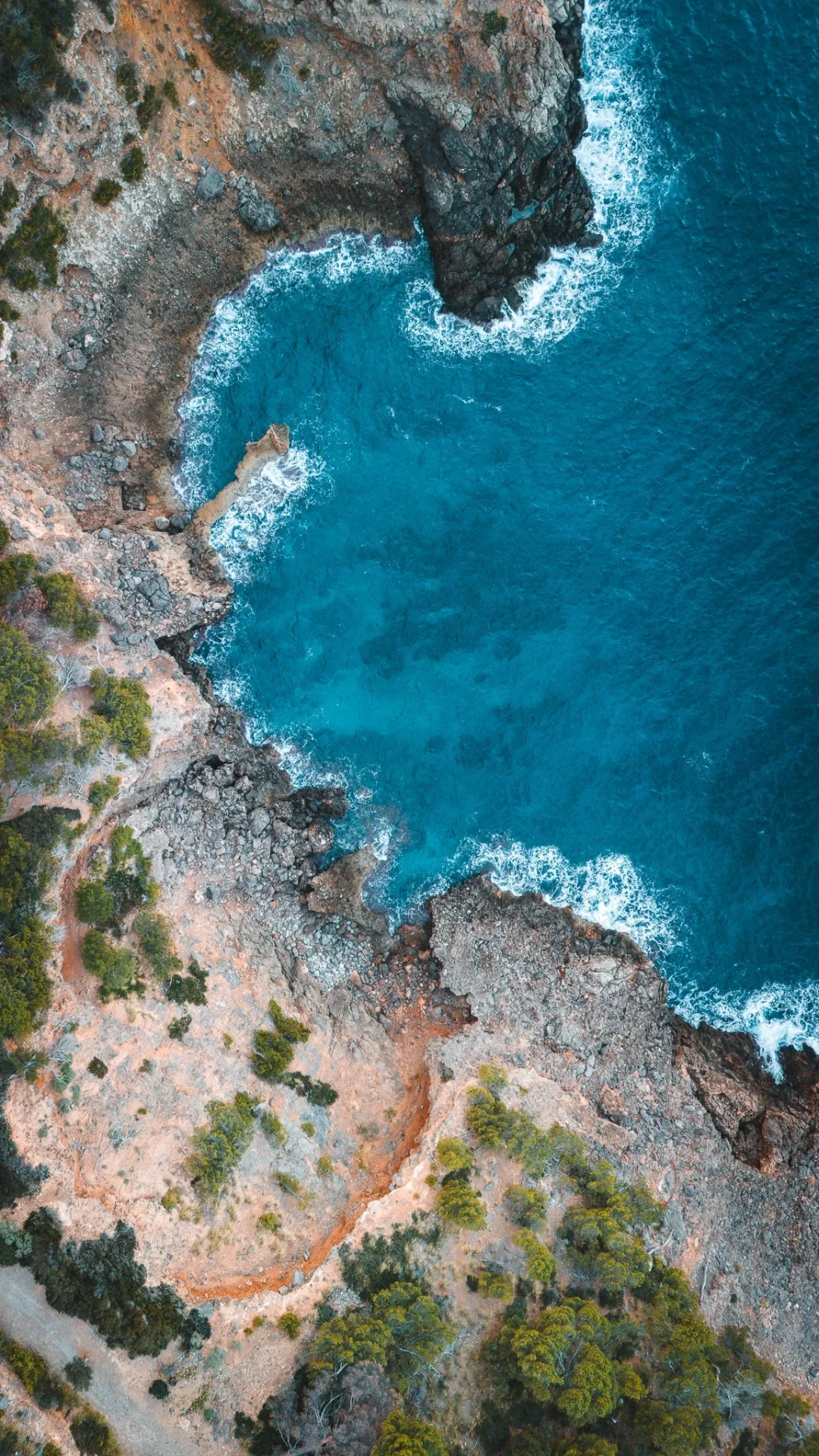 Rocky coastline and turquoise water from above
