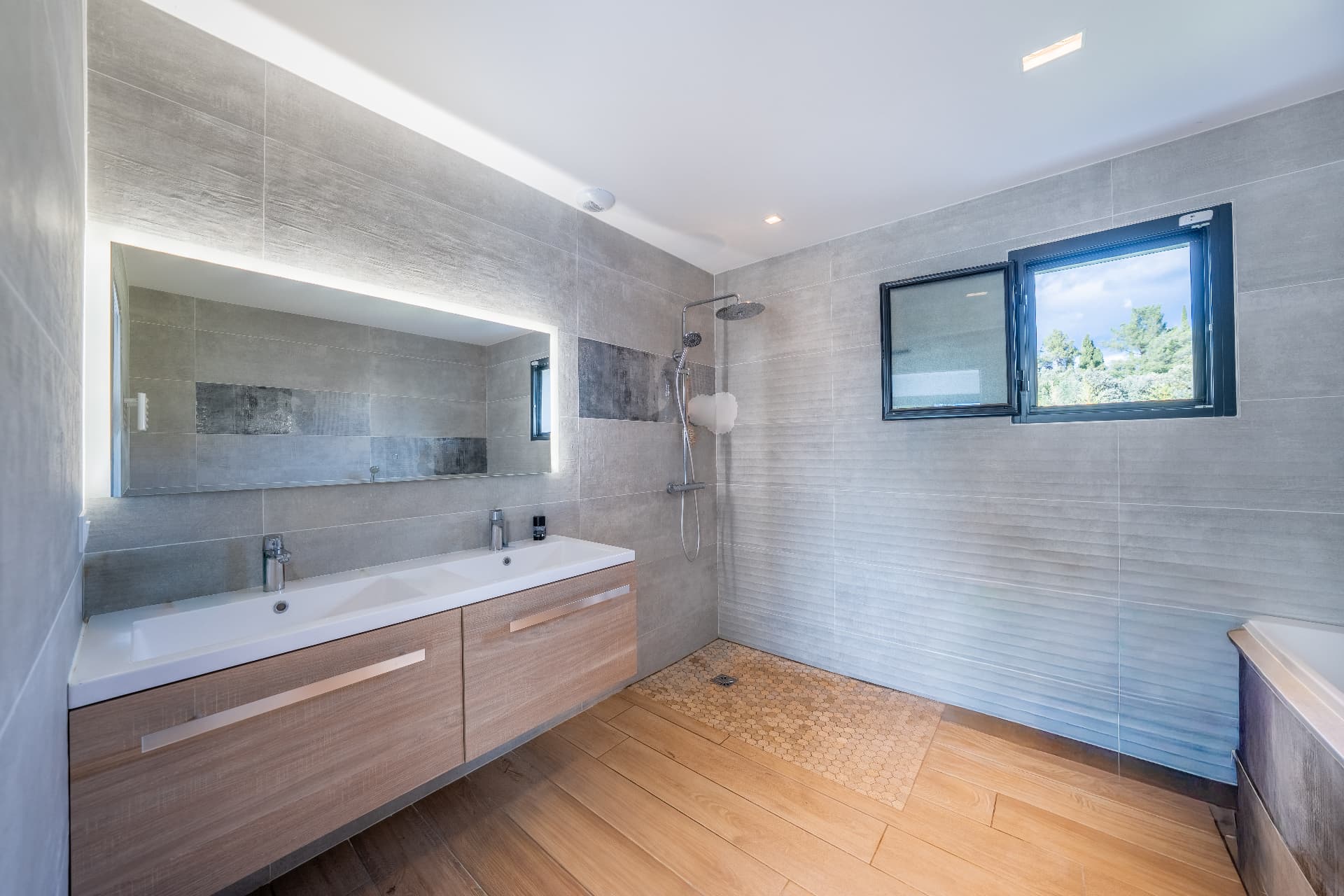 Bathroom with double vanity and walk-in shower